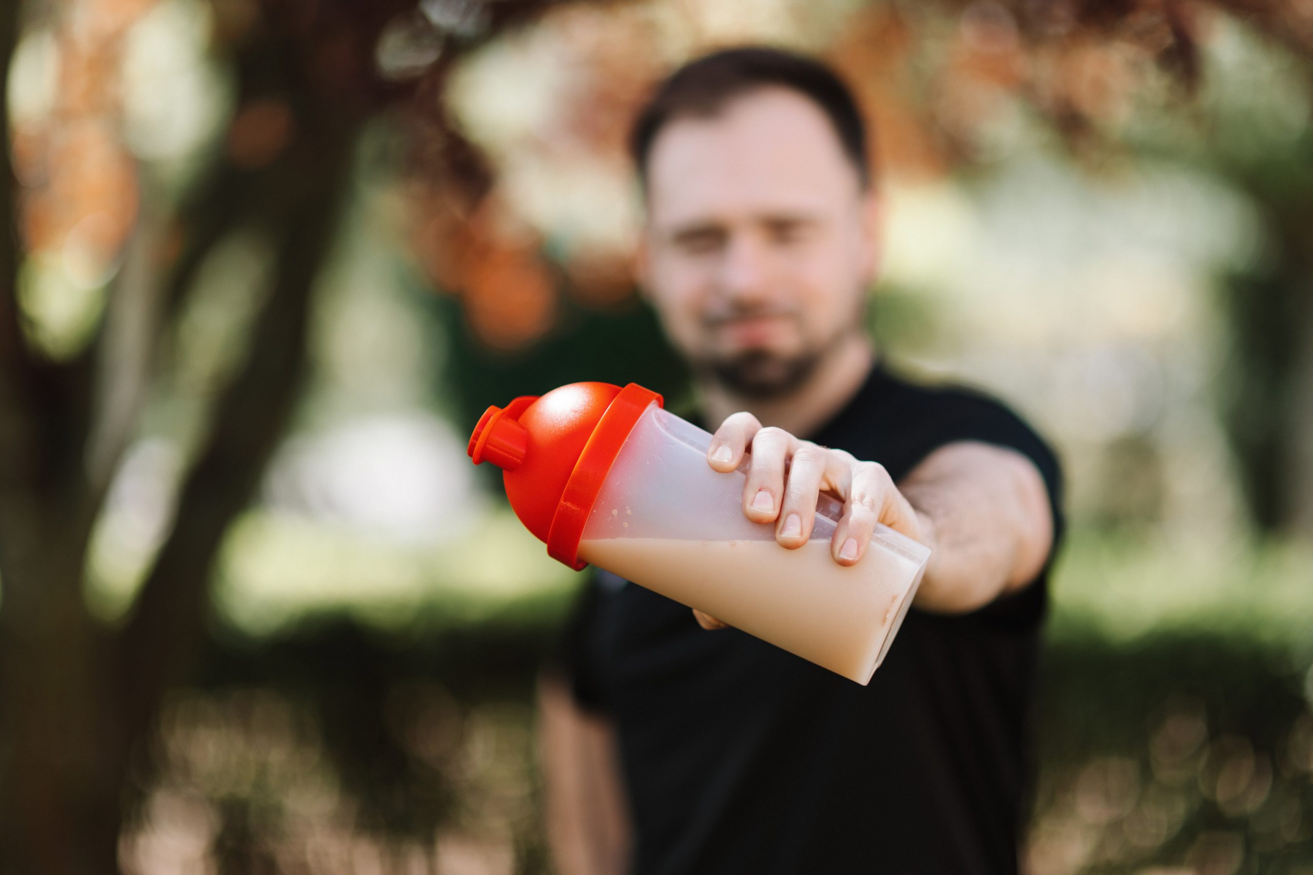 A man showing a protein shake